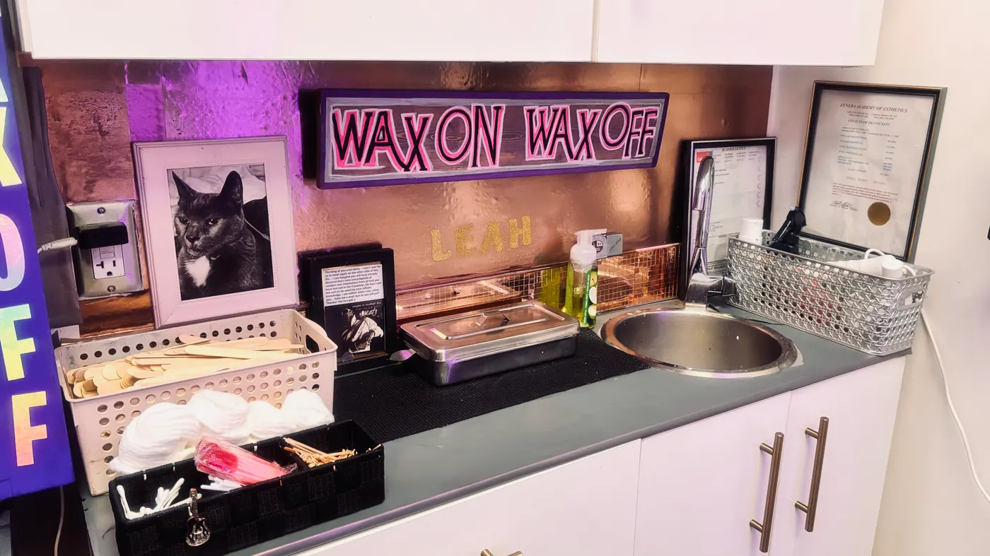 Prepared Sacred Beauty waxing station with clean supplies and wax warmers